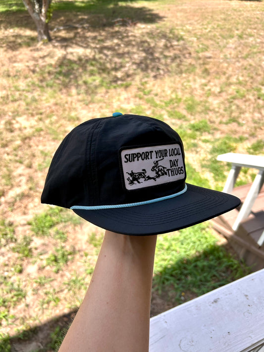 Black snapback with turquoise rope